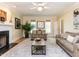Bright living room featuring a fireplace, light hardwood floors, and natural light at 315 King George Loop, Cary, NC 27511