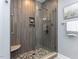Sleek tiled shower with a glass door and built-in bench at 315 King George Loop, Cary, NC 27511