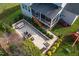 Aerial shot of the backyard showcasing the patio with dining and seating, playset, covered porch, and landscaping at 3209 Star Gazing Ct, Wake Forest, NC 27587
