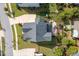 Overhead view of a home with a manicured lawn, stone patio, playset, and a long driveway at 3209 Star Gazing Ct, Wake Forest, NC 27587