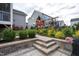 Beautiful backyard with a wooden play set, well-maintained lawn, and a stone patio with steps at 3209 Star Gazing Ct, Wake Forest, NC 27587