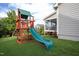Backyard featuring a wooden playset, grass, and a view of the house at 3209 Star Gazing Ct, Wake Forest, NC 27587