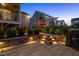 Backyard featuring a stone patio with steps, manicured landscaping, and a wooden play set in the distance at 3209 Star Gazing Ct, Wake Forest, NC 27587