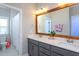 Bathroom features a double sink vanity, quartz countertops and decorative wood-framed mirror at 3209 Star Gazing Ct, Wake Forest, NC 27587
