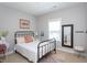 This bedroom boasts a modern design with a black iron bed frame and neutral color palette at 3209 Star Gazing Ct, Wake Forest, NC 27587