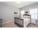 Neutral bedroom with a queen bed, two windows, and gray furniture at 3209 Star Gazing Ct, Wake Forest, NC 27587