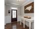 Inviting entryway with dark hardwood floors, wainscoting, and a rustic wooden accent piece at 3209 Star Gazing Ct, Wake Forest, NC 27587