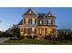 Two-story home at dusk with stone accents, covered front porch and manicured lawn at 3209 Star Gazing Ct, Wake Forest, NC 27587