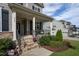 Inviting front porch with stone steps, seating, and stylish decor elements at 3209 Star Gazing Ct, Wake Forest, NC 27587