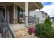 Cozy front porch with stone steps, a comfortable seating area, and lush landscaping at 3209 Star Gazing Ct, Wake Forest, NC 27587