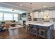 The open-concept kitchen features a center island with seating, stainless steel appliances, and access to the living area at 3209 Star Gazing Ct, Wake Forest, NC 27587