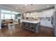 Open-concept kitchen with a large island, pendant lighting, and seamless flow to the living area at 3209 Star Gazing Ct, Wake Forest, NC 27587