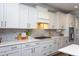 Elegant kitchen boasts white cabinets, marble backsplash, and modern hardware for a clean, sophisticated look at 3209 Star Gazing Ct, Wake Forest, NC 27587