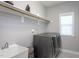 Functional laundry room featuring modern washer and dryer, sink, and ample shelving at 3209 Star Gazing Ct, Wake Forest, NC 27587