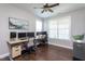 Spacious home office featuring multiple monitors, ceiling fan, and hardwood floors at 3209 Star Gazing Ct, Wake Forest, NC 27587