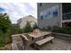 Charming patio with wood table and seating for outdoor dining, and view of the home at 3209 Star Gazing Ct, Wake Forest, NC 27587