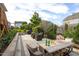 Stone patio with dining table, furniture, BBQ grill, and greenery, perfect for entertaining at 3209 Star Gazing Ct, Wake Forest, NC 27587