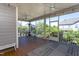 Large screened porch with wood floors, ceiling fans, and outdoor furniture overlooking the backyard at 3209 Star Gazing Ct, Wake Forest, NC 27587