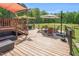 This back deck is spacious with a pergola, outdoor furniture, and a green lawn at 3214 Saddle Club Rd, Mebane, NC 27302