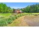 Spacious backyard with a pond, lush greenery, and inviting outdoor spaces at 3214 Saddle Club Rd, Mebane, NC 27302