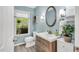 Stylish bathroom featuring a decorative mirror and modern vanity with ample storage space at 3214 Saddle Club Rd, Mebane, NC 27302