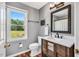 Bathroom featuring natural light, view of backyard, and modern vanity at 3214 Saddle Club Rd, Mebane, NC 27302
