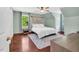 Bright bedroom featuring hardwood floors, large windows, and neutral decor at 3214 Saddle Club Rd, Mebane, NC 27302