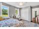 This bedroom features hardwood floors, two large windows, and a double door closet at 3214 Saddle Club Rd, Mebane, NC 27302