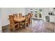 Open dining area featuring tile floors, wood table, and glass door leading to backyard at 3214 Saddle Club Rd, Mebane, NC 27302