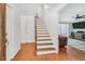 Bright foyer featuring hardwood floors, stairs, and entry to the living room at 3214 Saddle Club Rd, Mebane, NC 27302