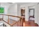 Upstairs hallway featuring hardwood floors and doors leading to bedrooms at 3214 Saddle Club Rd, Mebane, NC 27302