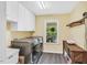 Well-equipped laundry room with stainless steel washer and dryer and overhead storage at 3214 Saddle Club Rd, Mebane, NC 27302