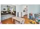 Connected living room and playroom featuring hardwood floors at 3214 Saddle Club Rd, Mebane, NC 27302