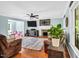 Open living room with fireplace, ceiling fan, and a cozy seating area at 3214 Saddle Club Rd, Mebane, NC 27302