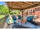 This pergola has outdoor furniture, a ceiling fan, and is perfect for relaxing outside at 3214 Saddle Club Rd, Mebane, NC 27302