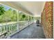 Spacious covered front porch featuring stone floor, brick facade and inviting seating at 3214 Saddle Club Rd, Mebane, NC 27302