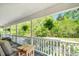 Inviting front porch with ferns, comfortable seating and view of large, private lawn at 3214 Saddle Club Rd, Mebane, NC 27302