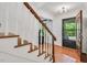Close up on wood and white staircase with front door and wooden floors at 3214 Saddle Club Rd, Mebane, NC 27302