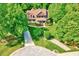 Aerial view of a beautiful home surrounded by lush greenery and mature trees, with a long driveway at 3581 Boulder Ct, Wake Forest, NC 27587