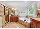 Bright bathroom featuring a soaking tub, glass enclosed shower, and wooden cabinets at 3581 Boulder Ct, Wake Forest, NC 27587