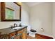 Elegant powder room with a decorative vanity, granite countertop, and hardwood flooring at 3581 Boulder Ct, Wake Forest, NC 27587