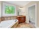 Bathroom features large window over tub for natural light and separate vanity at 3581 Boulder Ct, Wake Forest, NC 27587