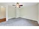 Neutral bedroom offers carpeted floor, a ceiling fan, and a large closet at 3581 Boulder Ct, Wake Forest, NC 27587