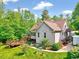 Exterior elevation featuring back deck, gray siding, and lush landscape at 3581 Boulder Ct, Wake Forest, NC 27587