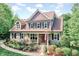 Beautiful two-story home with manicured landscaping, a stone-accented porch, and classic shutters at 3581 Boulder Ct, Wake Forest, NC 27587