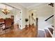 Elegant hallway with hardwood floors, decorative lighting, and arched openings to other living spaces at 3581 Boulder Ct, Wake Forest, NC 27587