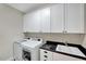 Well-lit laundry room with modern appliances and storage cabinets at 3581 Boulder Ct, Wake Forest, NC 27587