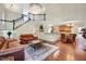 Spacious living room with fireplace, hardwood floors, staircase, and kitchen view at 3581 Boulder Ct, Wake Forest, NC 27587