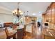 Open concept kitchen and dining area featuring hardwood floors and wood cabinets at 3581 Boulder Ct, Wake Forest, NC 27587
