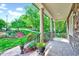 Relaxing porch with stone columns, iron railing, and views of the well-maintained front yard at 3581 Boulder Ct, Wake Forest, NC 27587